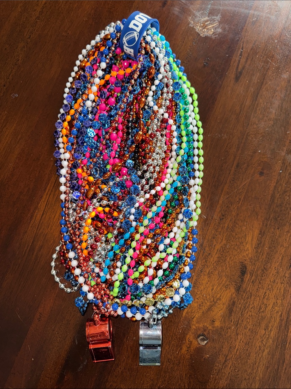 large collection colorful plastic Mardi Gras party bead necklaces whistle dress